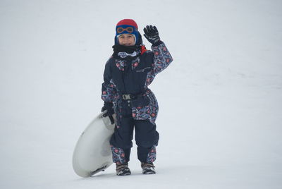 Full length of girl standing on snow field