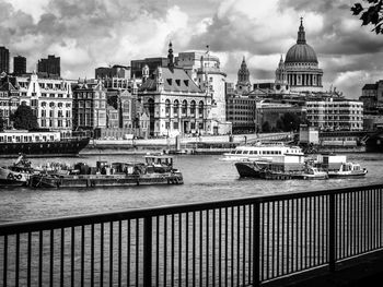 View of boats in river with buildings in background