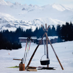 Close-up of firecamp and pot against sky during winter