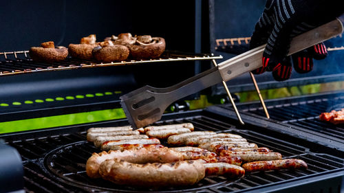 High angle view of man preparing food on barbecue grill