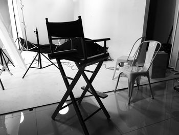 Empty chairs and tables on tiled floor