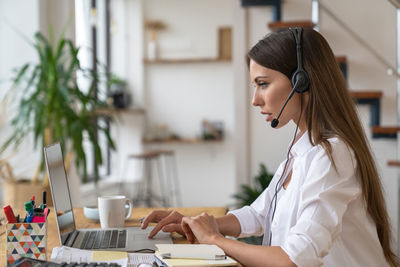 Side view of businesswoman working in office