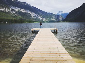 Pier over lake against sky