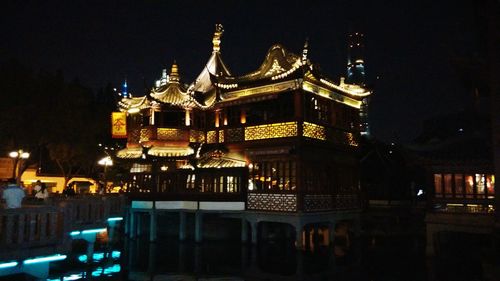 Illuminated building against sky at night