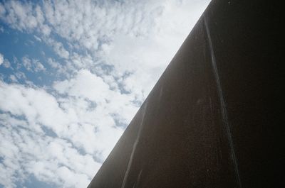 Low angle view of building against cloudy sky