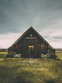 Built structure on field against sky