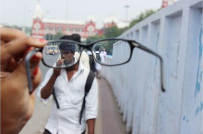 Cropped image of woman holding camera