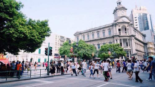 People on street in front of city