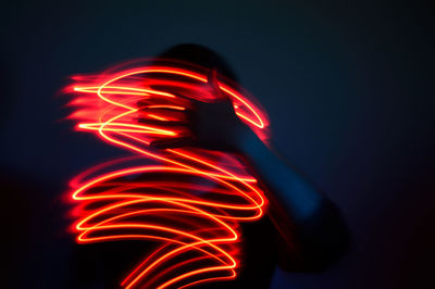 Close-up of man with light painting at night
