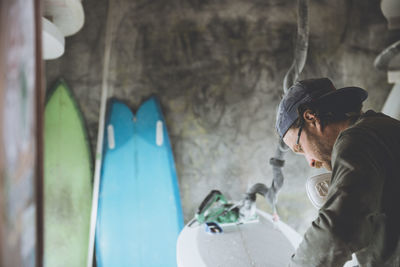 Surfboard shaper refining a new design