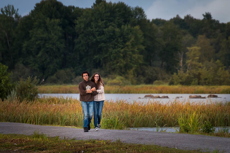 tree, lifestyles, casual clothing, leisure activity, full length, water, standing, lake, rear view, nature, tranquility, grass, tranquil scene, beauty in nature, sky, growth, scenics, outdoors