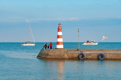 Sailboat on sea against sky