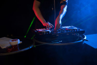 Midsection of man standing in nightclub