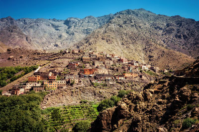 Aerial view of houses and mountains against sky