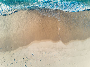 Aerial view of sea waves at beach