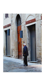 Rear view of man standing outside building