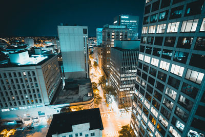 High angle view of illuminated buildings in city at night