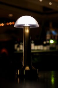 Close-up of illuminated lamp on table