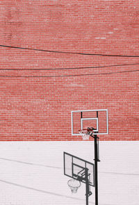 View of basketball hoop against brick wall