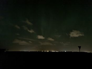 Silhouette landscape against sky at night