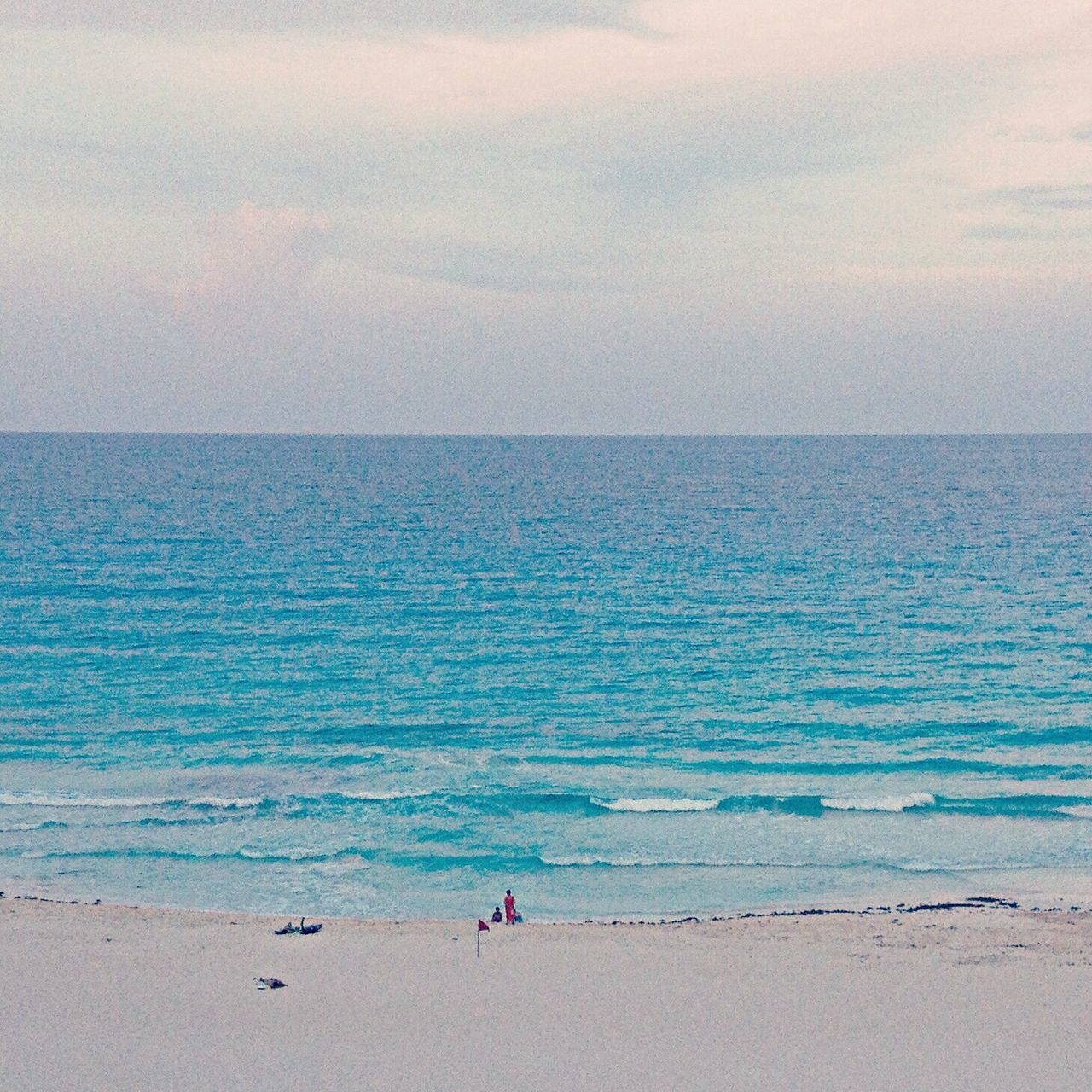 sea, horizon over water, water, beach, shore, scenics, sky, beauty in nature, tranquil scene, tranquility, sand, vacations, nature, leisure activity, blue, lifestyles, idyllic, wave, incidental people