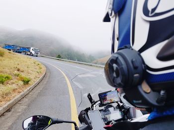 View of man riding motorcycle on road