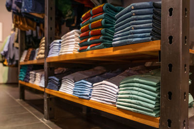 Close-up of stack of clothing on table for sale in store