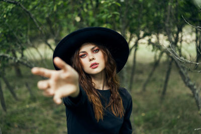 Portrait of young woman standing outdoors