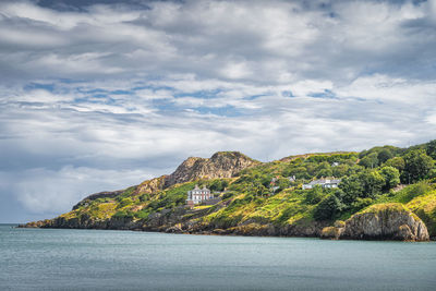 Howth cliff walk with some residential houses and lush green vegetation, dublin