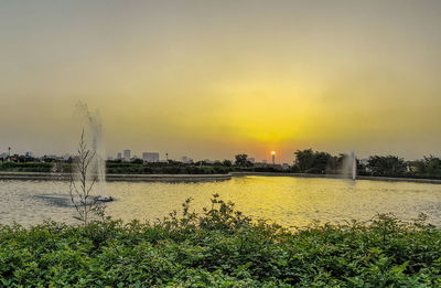 Scenic view of lake against sky during sunset