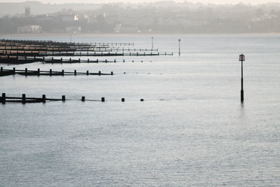 Wooden posts in sea