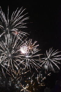 Low angle view of firework display at night