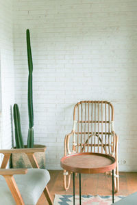 Empty chairs and table against wall at home