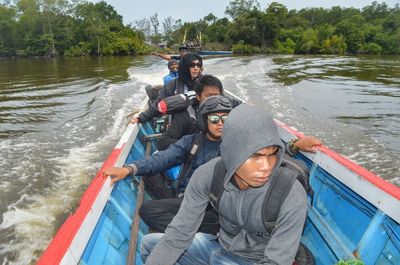 People on boat in river