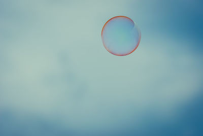 Close-up of bubbles against rainbow in sky