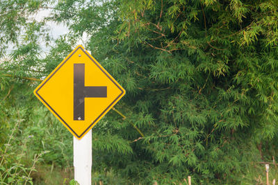 Road sign against trees