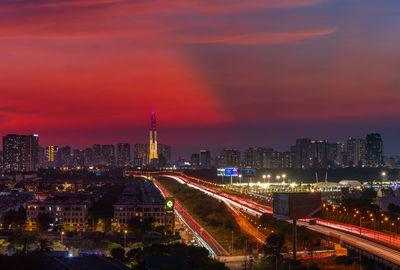 High angle view of illuminated buildings against sky at night