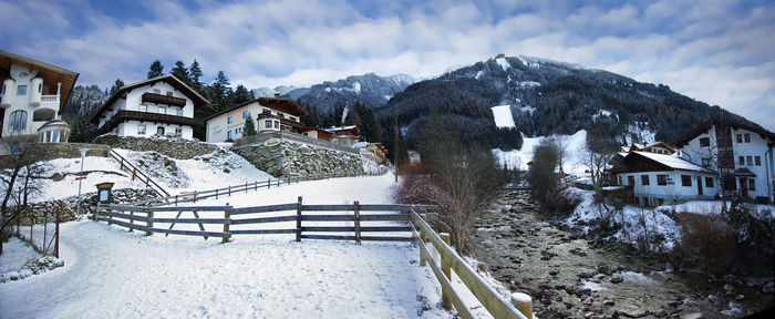 A panoramic winter view of a rocky mountain river and ahorn mountain in the background