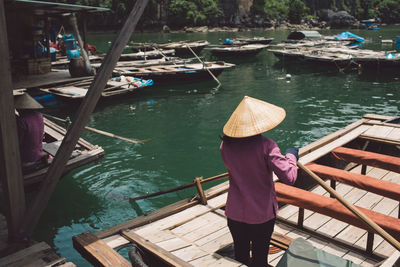 Rear view of man rowing boat in sea