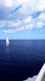 Sailboat sailing on sea against sky