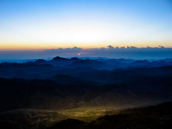 Scenic view of silhouette mountains against sky during sunset