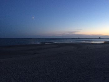 Scenic view of sea against clear sky at sunset
