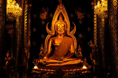 Statue in illuminated temple