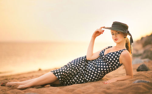 Portrait of young woman relaxing at beach