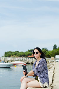 Happy business woman relaxing, working in beach at adriatic seaside. technology. summer vacation