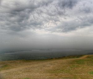 Scenic view of landscape against cloudy sky