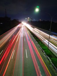 High angle view of light trails on highway at night