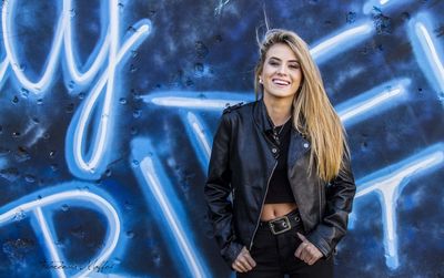 Portrait of smiling young woman standing outdoors