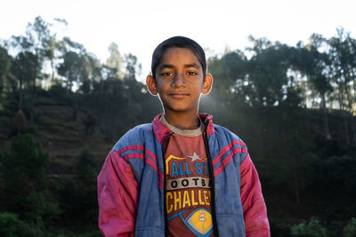 Almora, uttarakhand,portrait of an indian village kid captured in sunrise. indian farmer's kid.