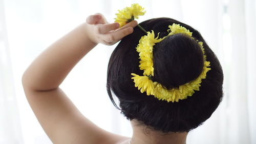 Midsection of woman holding yellow flower